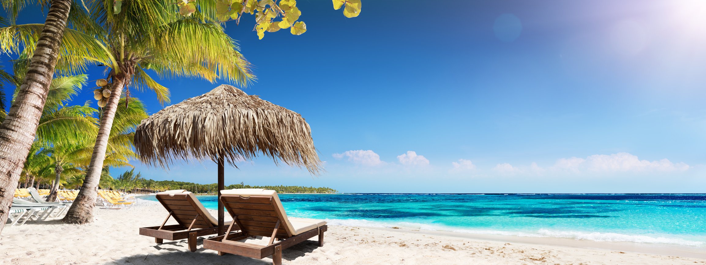 Caribbean Palm Beach With Wooden Chairs And Straw Umbrella - Idyllic Island